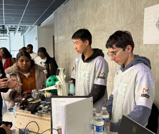 GNCE Mercury members showing our robot to visitors at the Clark University robotics showcase