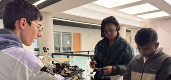 Team member demonstrating the robot to students at Clark University