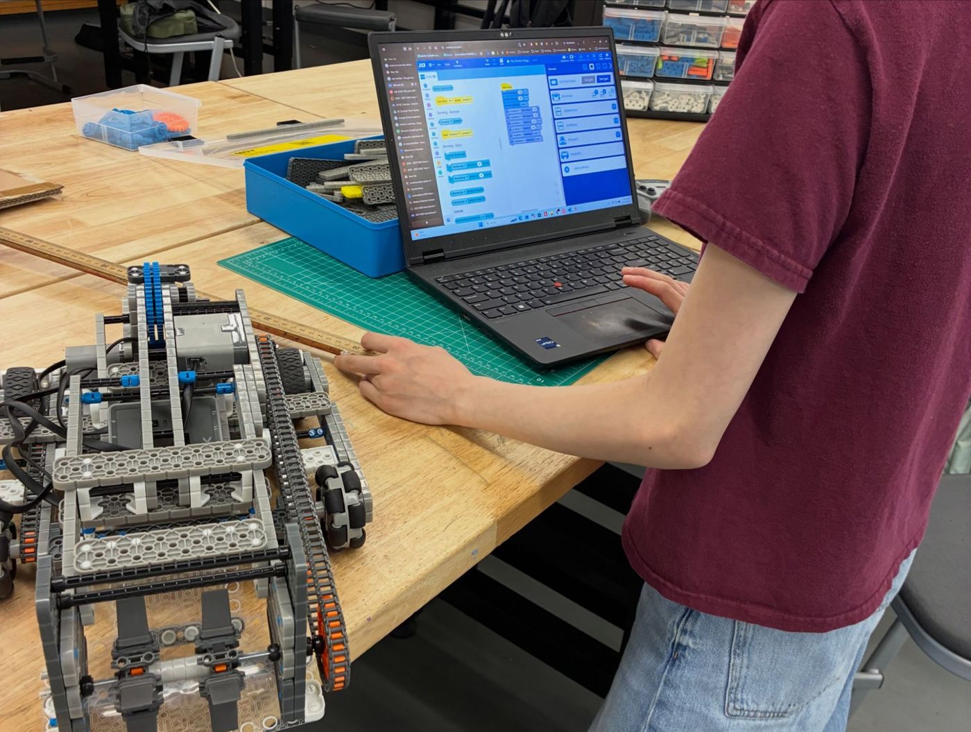 Programming a VEX IQ robot with block code on a laptop
